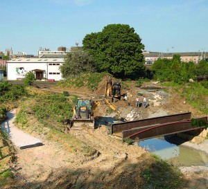 Working on the pond. The environment centre is in the background