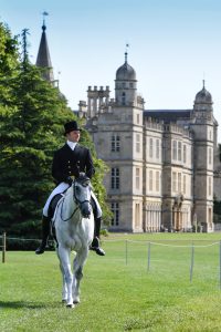 Harry Dzenis riding XAM, walking towards the dressage arena for his test during the Land Rover Burghley Horse Trials in the grounds of Burghley House near Stamford in Lincolnshire in the UK between 29th August and 2nd September 2018